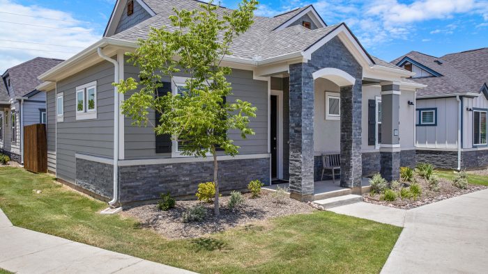 a home with a front yard and driveway at The VLux Trails