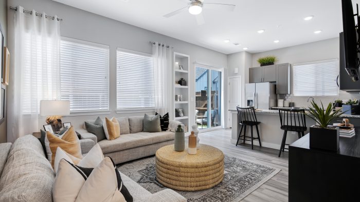 a living room and kitchen area with a ceiling fan at The VLux Trails