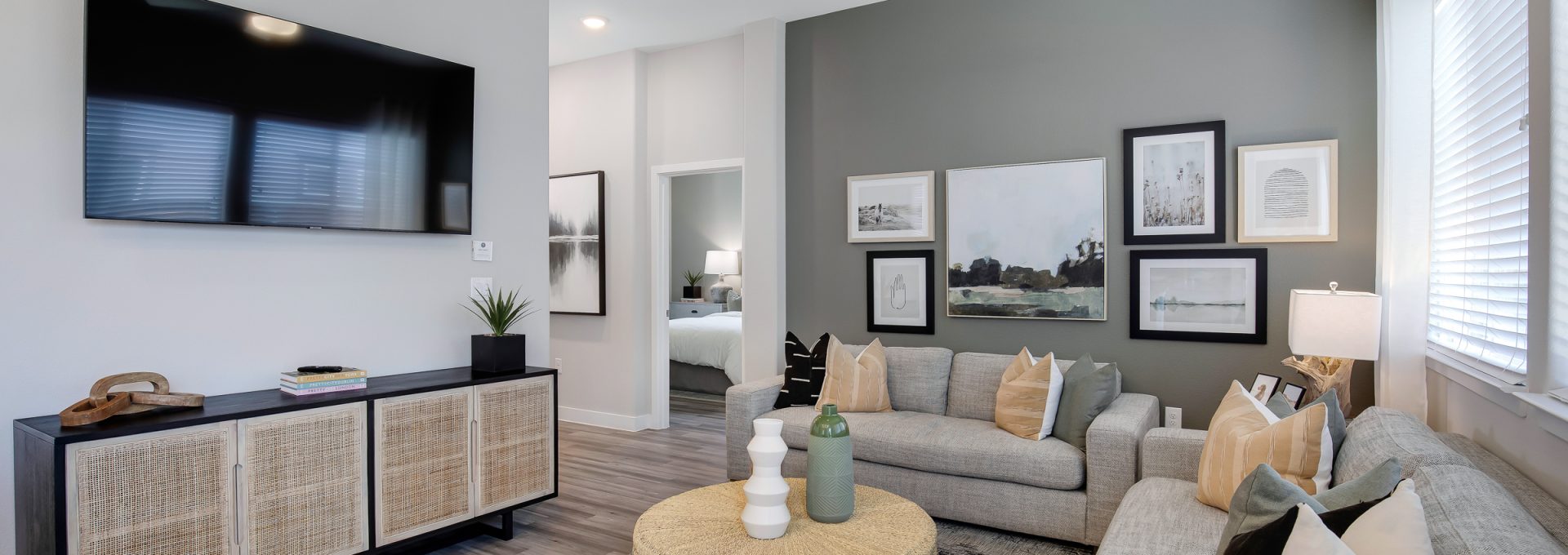 a living room with gray walls and a ceiling fan at The VLux Trails