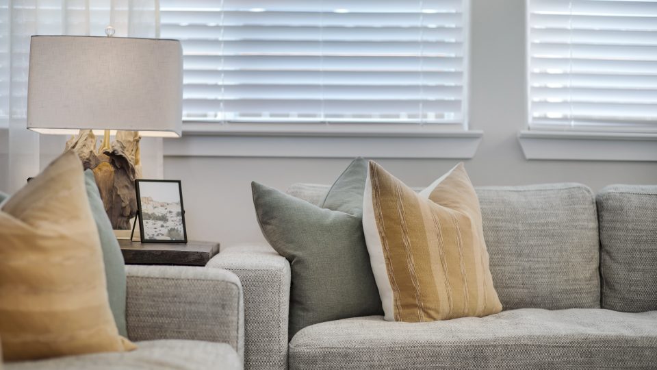 a living room with two couches and a lamp at The VLux Trails