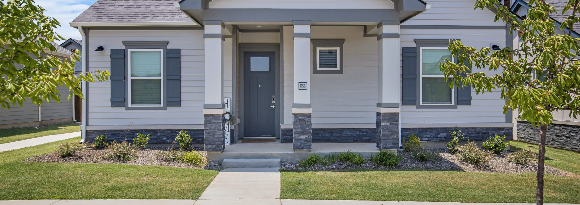 a home with a front yard and driveway at The VLux Trails