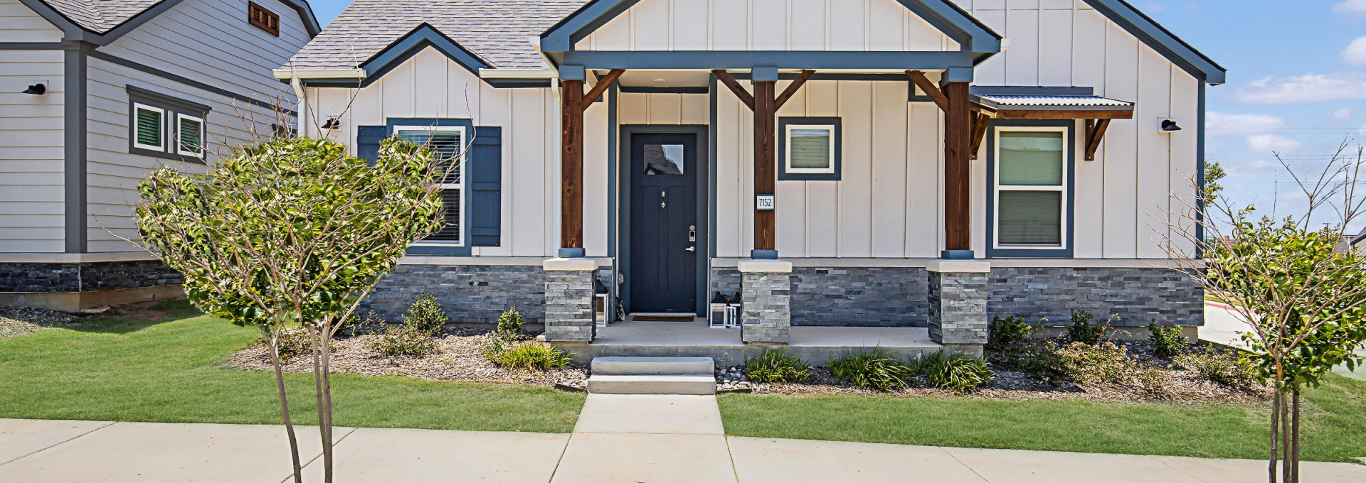 a home with a front yard and a driveway at The VLux Trails